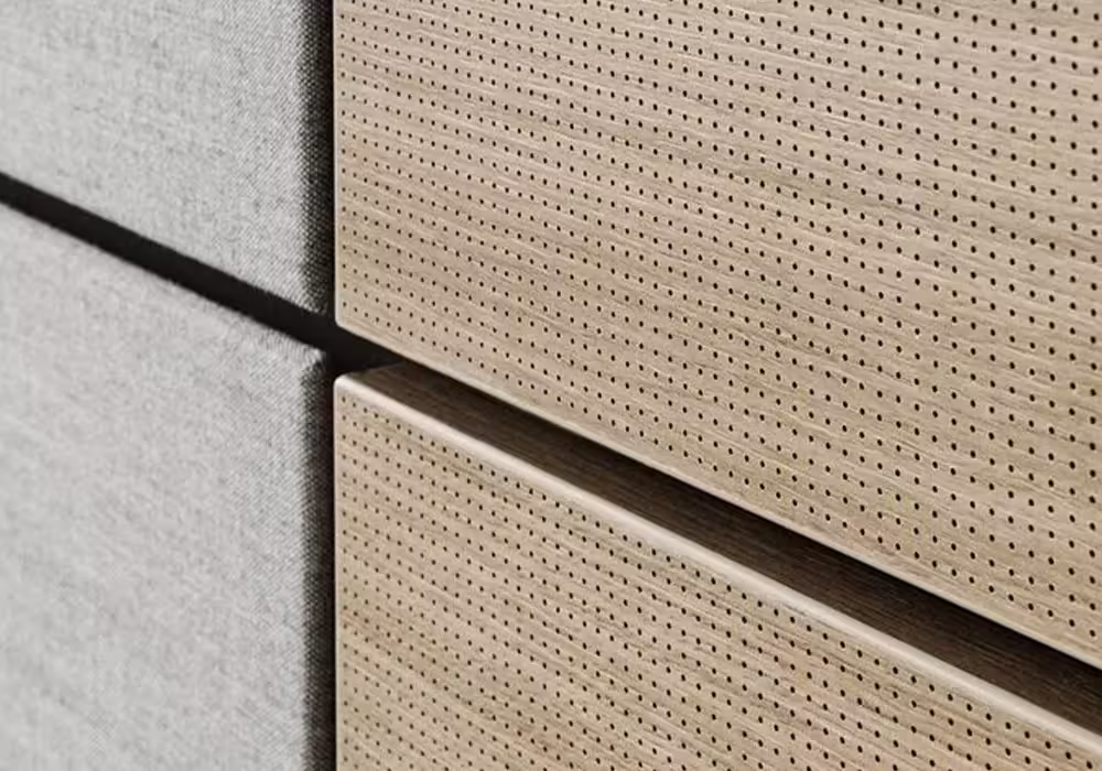 Perforated acoustic wood panel close-up — perforation pattern and natural wood texture detail