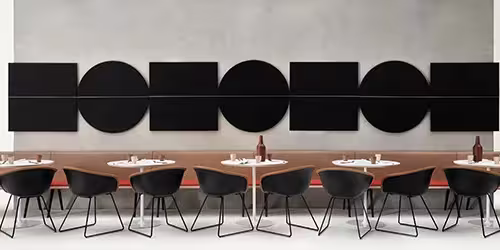 Restaurant acoustics detail — acoustic treatment for reduced noise buildup and clearer conversation